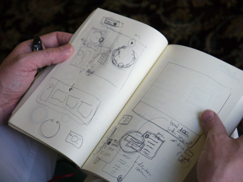 A Person Holding a Journal with Drawings on it